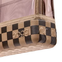 Close-up of a clear plastic zip pouch with a beige and black checkerboard patterned base and embossed BOGG branding.