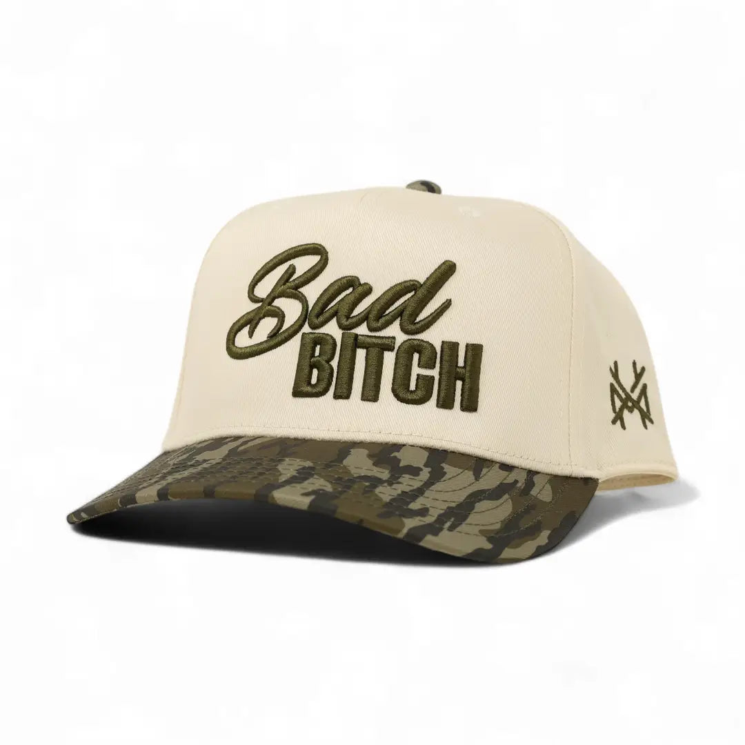 Beige cap with 'Bad Bitch' text and camouflage brim on a white background