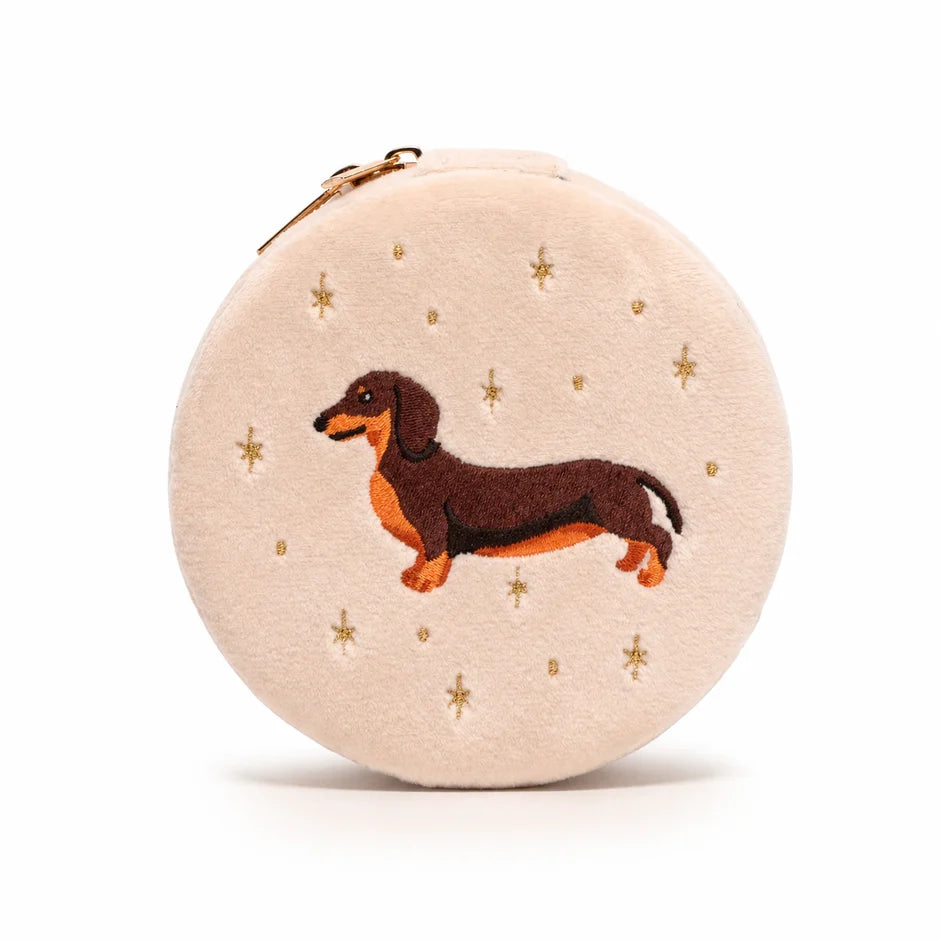 Round beige pouch with embroidered dachshund and gold stars on a white background