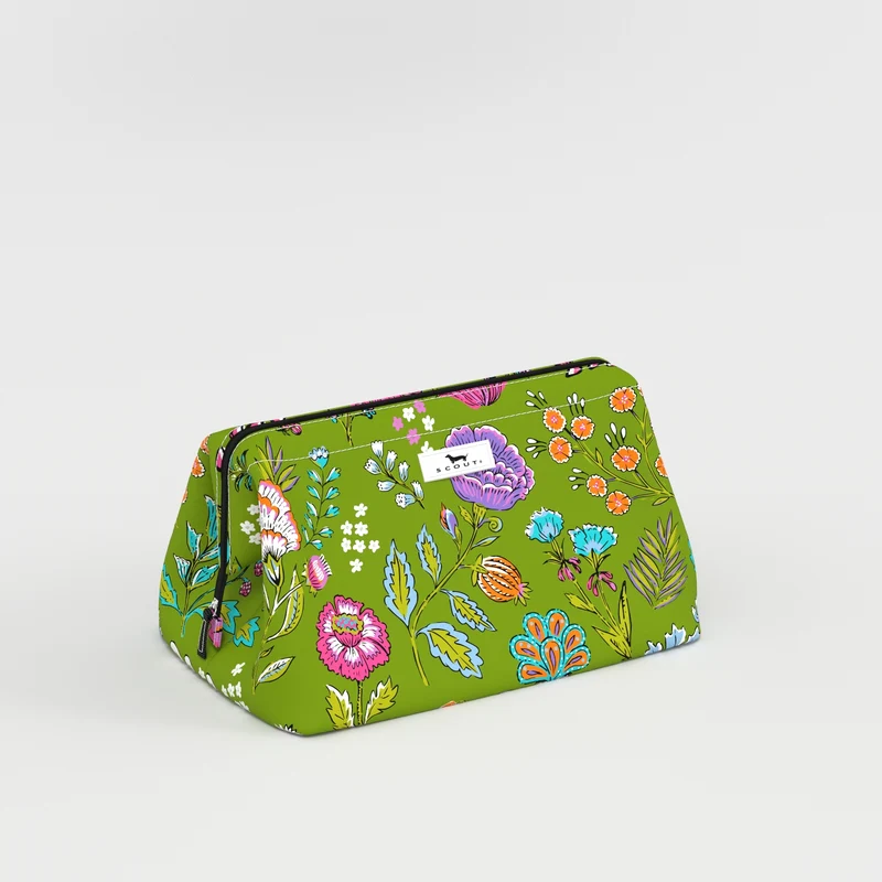 A green cosmetic pouch with a colorful floral and botanical print, featuring a small white brand label on the front, set against a plain light gray background.
