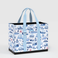 A tote bag with a blue and white illustrated pattern of London landmarks and street scenes, featuring light blue and white striped handles and a black base, shown on a light gray background.